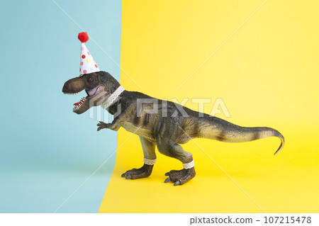 a dinosaur, dressed up in lace and a paper party hat 107215478