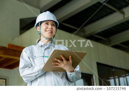 Women in work clothes, helmet 107215746