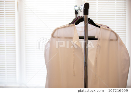 Medical white coats hanging on a hanger 107216999