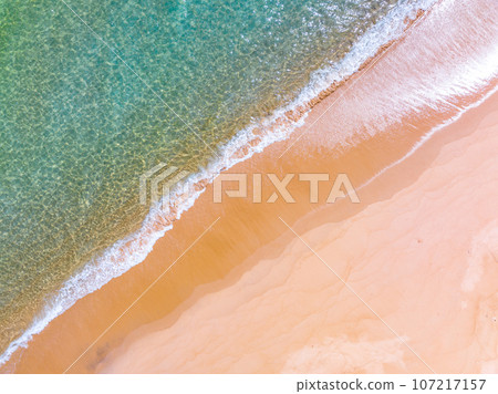 Waves crashing on sandy shore,Sea ocean waves background 107217157