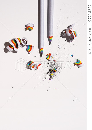 Lead pencil with colourful shavings on white. Lead pencil with colourful shavings on white. 107218262