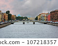 Scenic sunset cityscape over Arno River, St Trinity Bridge and colorful old houses along the river 107218357
