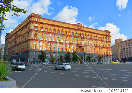 A building in warm colors against a blue sky A building in warm colors against a blue sky 107218363