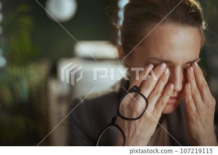 stressed modern business woman in modern green office 107219115