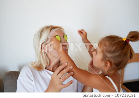 Daughter helps mom with beauty treatments Daughter helps mom with beauty treatments 107219151