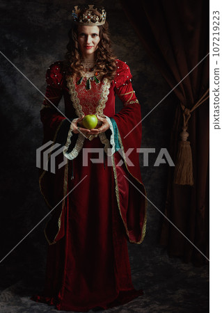 Full length portrait of medieval queen in red dress 107219223