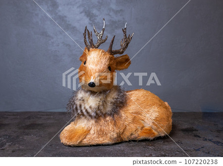 plush reindeer on a gray background. fawn statue for new year decor 107220238