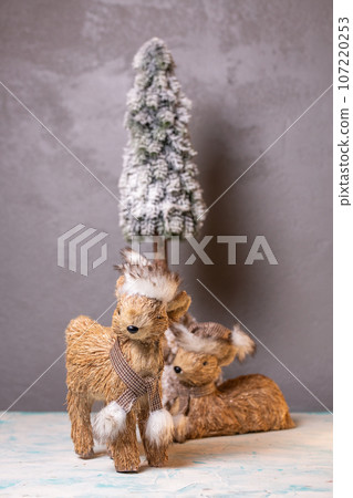 two deer on a gray background. fawn statue for new year decor 107220253