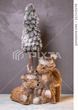 two deer on a gray background. fawn statue for new year decor 107220256