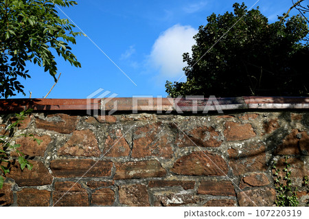 Old Stone Built Garden Wall in a Country Estate Garden 107220319