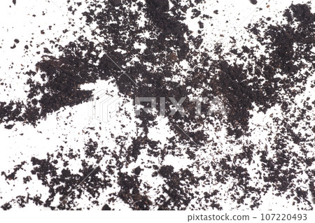 Grain of black earth on white background. Natural soil texture. 107220493
