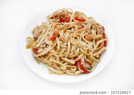Korean Udon noodles with meat on a white plate. Delicious spicy meat breakfast. 107220627