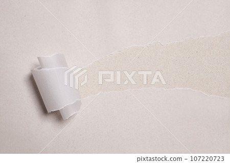 Torn paper with opening showing white background. Torn paper with opening showing white background. 107220723