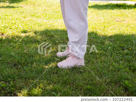 Woman legs in pink sneakers Woman legs in pink sneakers 107222491