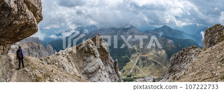 Adventurous hike up to mount Lagazuoi in the Dolomite Alps, view on the Valparola pass, South Tirol in Italy Adventurous hike up to mount Lagazuoi in the Dolomite Alps, view on the Valparola pass, South Tirol in Italy 107222733