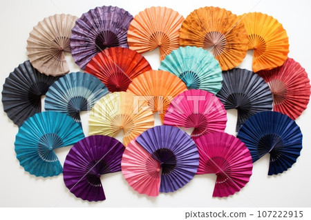 vibrant collection of colorful hand fans spread out on a white background vibrant collection of colorful hand fans spread out on a white background 107222915