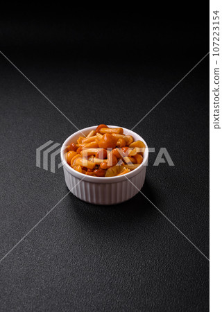 Delicious pickled honey mushrooms with salt and spices in a ceramic plate 107223154