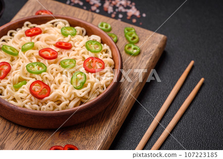 Delicious Asian cuisine dish with rice noodles, peppers, mushrooms and spices 107223185