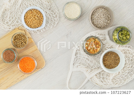 Grocery in bowls. Protein pulse and groats that is dried and then soaked and cooked before eating. Vegetarian organic product. Top view. Grocery in bowls. Protein pulse and groats that is dried and then soaked and cooked before eating. Vegetarian organic product. Top view. 107223627
