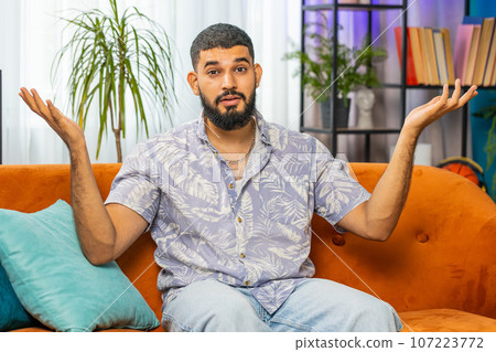 Indian young man asking why, what reason of failure, demonstrating disbelief irritation by troubles Indian young man asking why, what reason of failure, demonstrating disbelief irritation by troubles 107223772