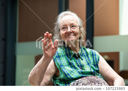 Smiling and waving 84 yo grandmother, Belgium Smiling and waving 84 yo grandmother, Belgium 107223983