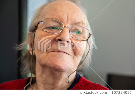Portrait of an 83 yo white woman looking away in her chair, Belgium Portrait of an 83 yo white woman looking away in her chair, Belgium 107224035