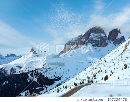 Winter mountain landscape with road on slope. View from Pordoi Pass ( Italy) Winter mountain landscape with road on slope. View from Pordoi Pass ( Italy) 107224478