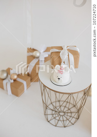 Modern table with white delicious cake in form of bear on it Modern table with white delicious cake in form of bear on it 107224710