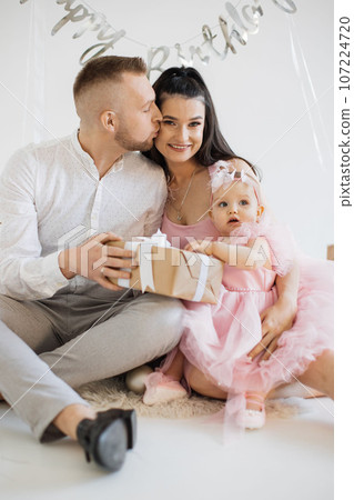 Spouse with baby girl sharing birthday happiness together Spouse with baby girl sharing birthday happiness together 107224720