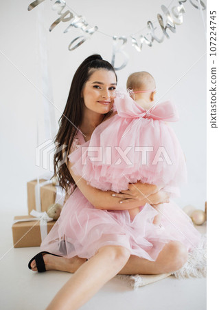 Mother and little daughter celebrating birthday in studio Mother and little daughter celebrating birthday in studio 107224745