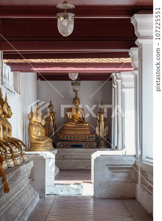 Diminishing perspective interior view at corridor around the Wat yai suwannaram temple is leading to Buddha statue. 107225551