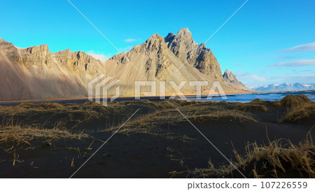 Beautiful vestrahorn mountains and hills in iceland with black sand beach and spectacular scandinavian landscapes. Stokksnes beach with panoramic view of icelandic nature. Handheld shot. 107226559
