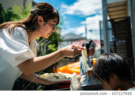 A family making somen noodles in the garden A family making somen noodles in the garden 107227698