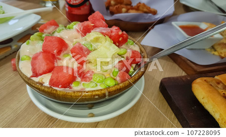 Fresh mix fruit and vegetable salad on ceramic bowl Healthy green salad with water melon, green beans, corn and lettuce Fresh mix fruit and vegetable salad on ceramic bowl Healthy green salad with water melon, green beans, corn and lettuce 107228095