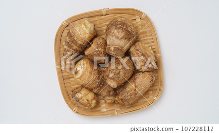 Taro on a colander, white background Taro on a colander, white background 107228112