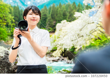 Female business photographer taking profile photos of men Female business photographer taking profile photos of men 107228450