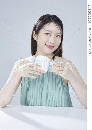 beauty concept photo of korean asain beautiful woman with cosmetic and a recycle bottle 107230345