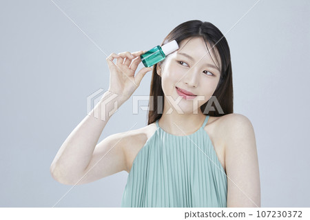 beauty concept photo of korean asain beautiful woman with cosmetic and a recycle bottle 107230372