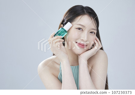 beauty concept photo of korean asain beautiful woman with cosmetic and a recycle bottle 107230373
