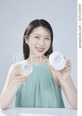 beauty concept photo of korean asain beautiful woman with cosmetic and a recycle bottle 107230397