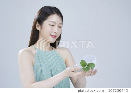 beauty concept photo of korean asain beautiful woman with cosmetic and a recycle bottle 107230443