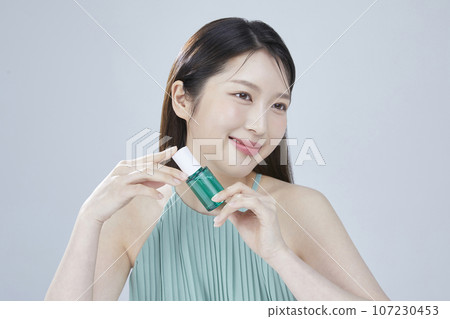 beauty concept photo of korean asain beautiful woman with cosmetic and a recycle bottle 107230453