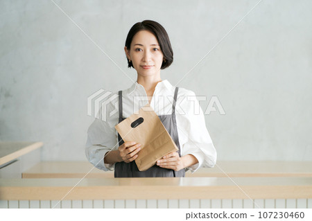 Image of a woman working in a cafe Image of a woman working in a cafe 107230460