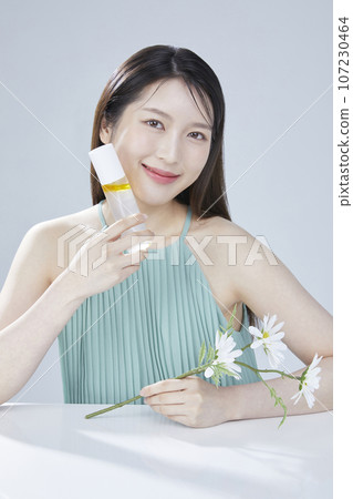 beauty concept photo of korean asain beautiful woman with cosmetic and a recycle bottle 107230464