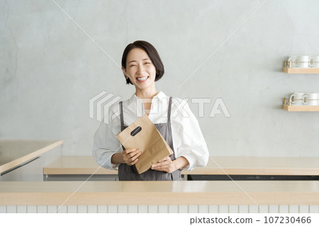 Image of a woman working in a cafe 107230466