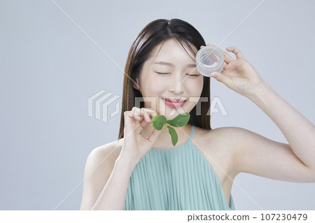 beauty concept photo of korean asain beautiful woman with cosmetic and a recycle bottle 107230479