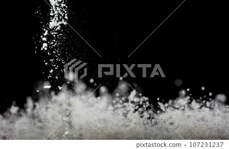 Tapioca starch flour fly explosion, White powder tapioca starch fall down in air. Seasoning flour powder is element material. Eyeshadow crush make up. Black background Isolated series two of images 107231237