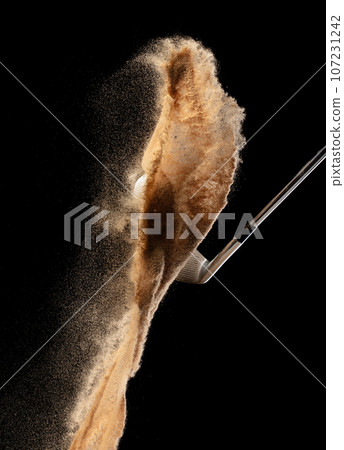 Golf ball tee explode from sand bunker. Golfer hit ball with club to sand explosion to green. Golf club hit ball tee in sand wedge bunker explosion. Black background isolated series two of images Golf ball tee explode from sand bunker. Golfer hit ball with club to sand explosion to green. Golf club hit ball tee in sand wedge bunker explosion. Black background isolated series two of images 107231242