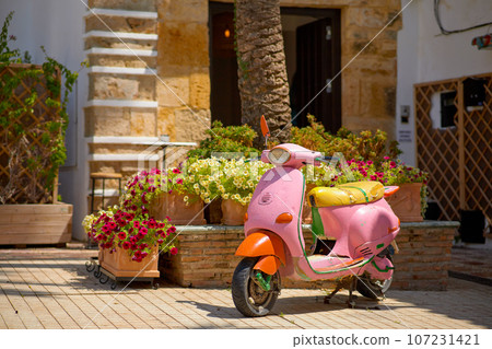 Colorful scooter on the street in the old town  107231421
