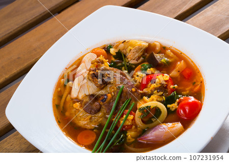 Lamb's soup boiled with rice, vegetables, onion and garlic in bowl 107231954